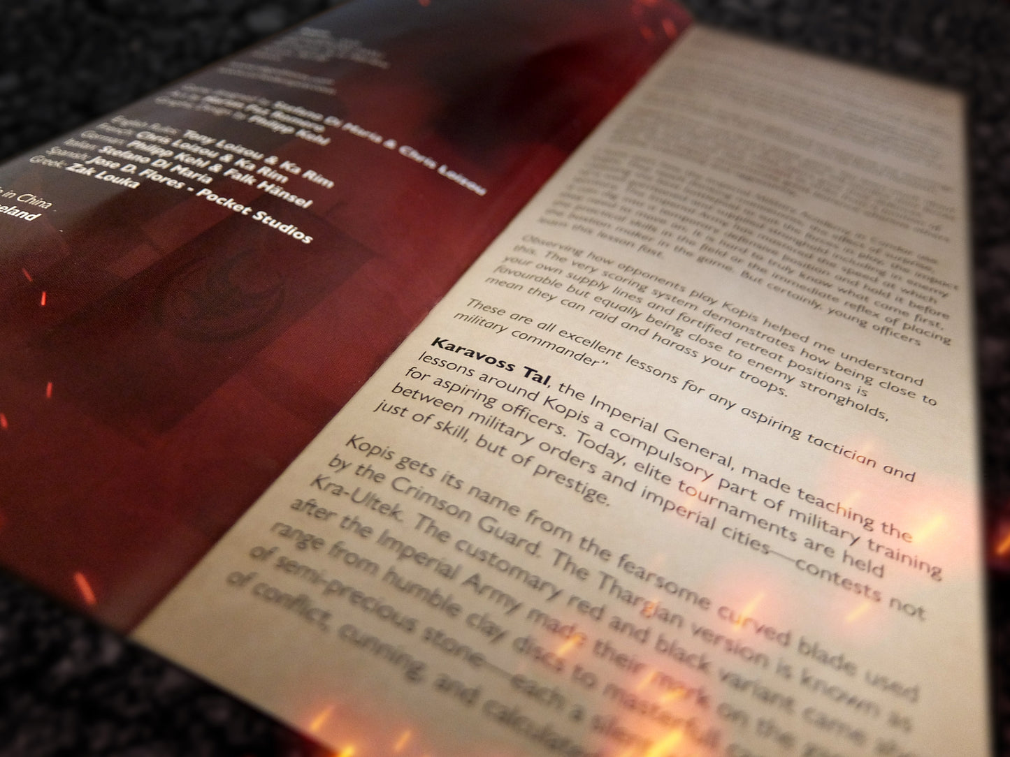 Close-up of kopis rule book with red cover and text on a dark surface